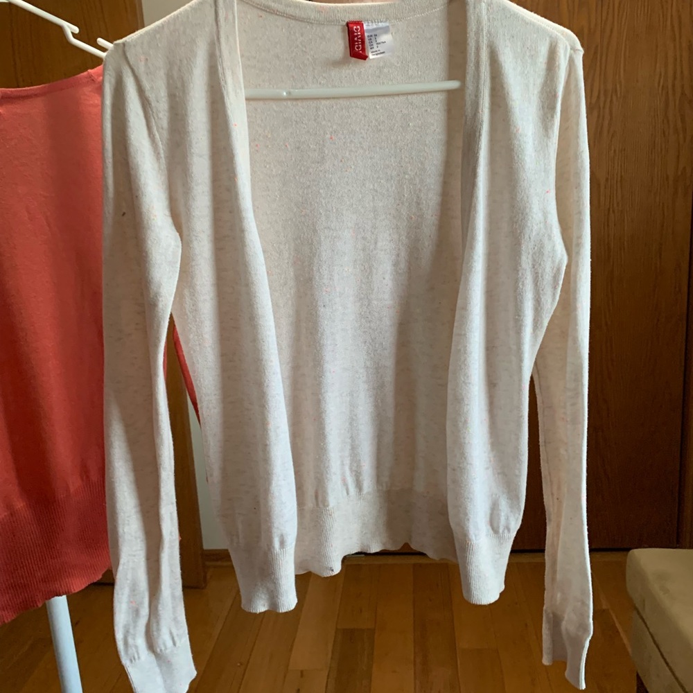 Off-white with sprinkles of fluorescent colors. Size Small